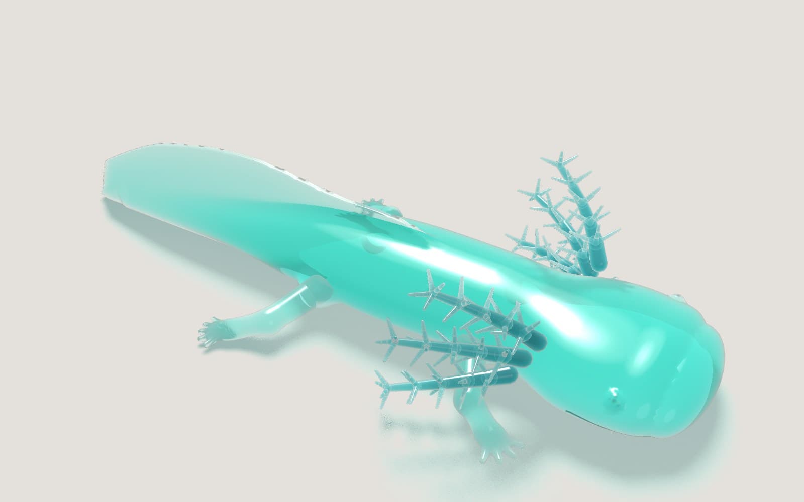 A glossy teal gummy axolotl with feathered gills on a pale paper table